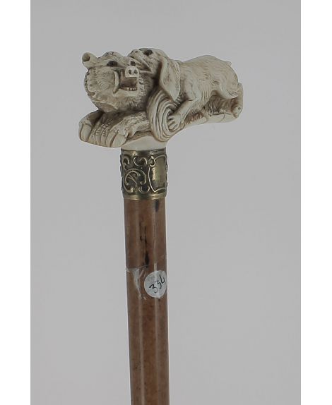 Ivory handle representing dog biting a boar. Malacca shaft