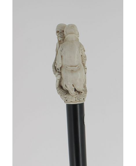Ivory handle, 2 skeletons wearing coats holding each other
