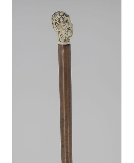 Erotic Ivory knob of a man head composed of many naked woman and in the back a couple making love.